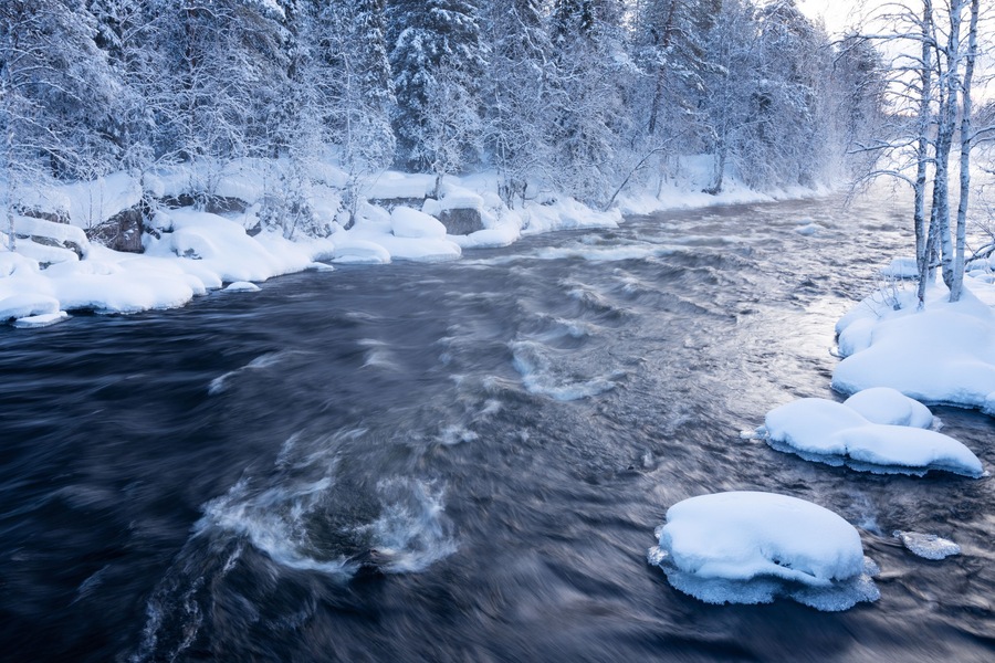 River rapids in Käylä near Kuusamo, Northern Finland on a cold winter morning.
