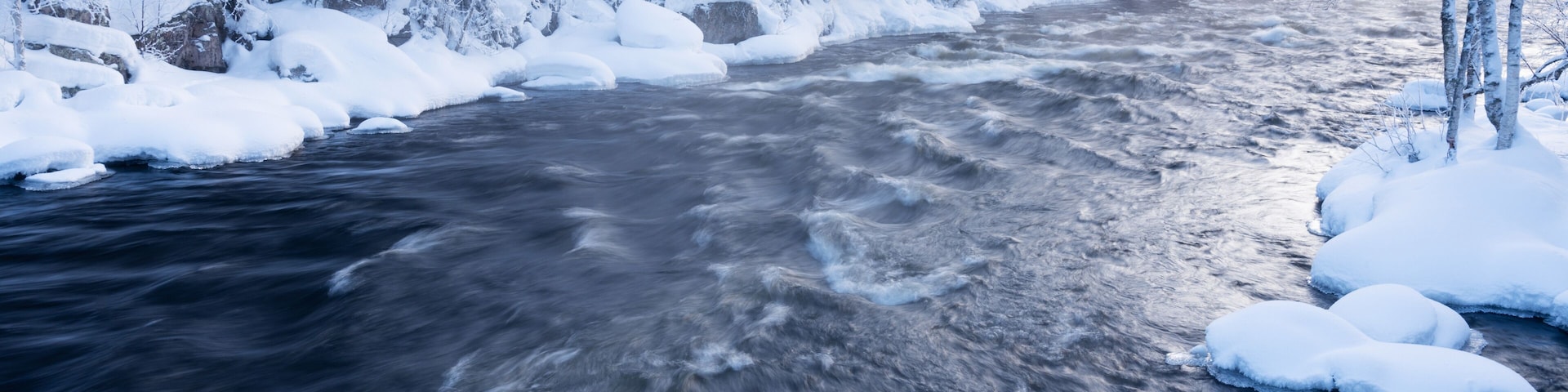 River rapids in Käylä near Kuusamo, Northern Finland on a cold winter morning.