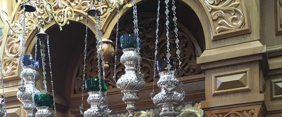 An ornate wooden structure with intricate carvings and a framed religious icon.
