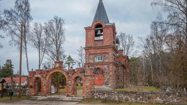 A historic church with a bell tower and arched entrance.