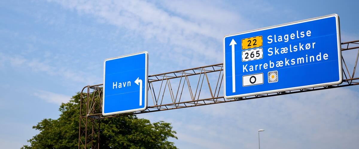 A highway sign with directions to Slagelse, Skælsker, and Karrebæksminde.