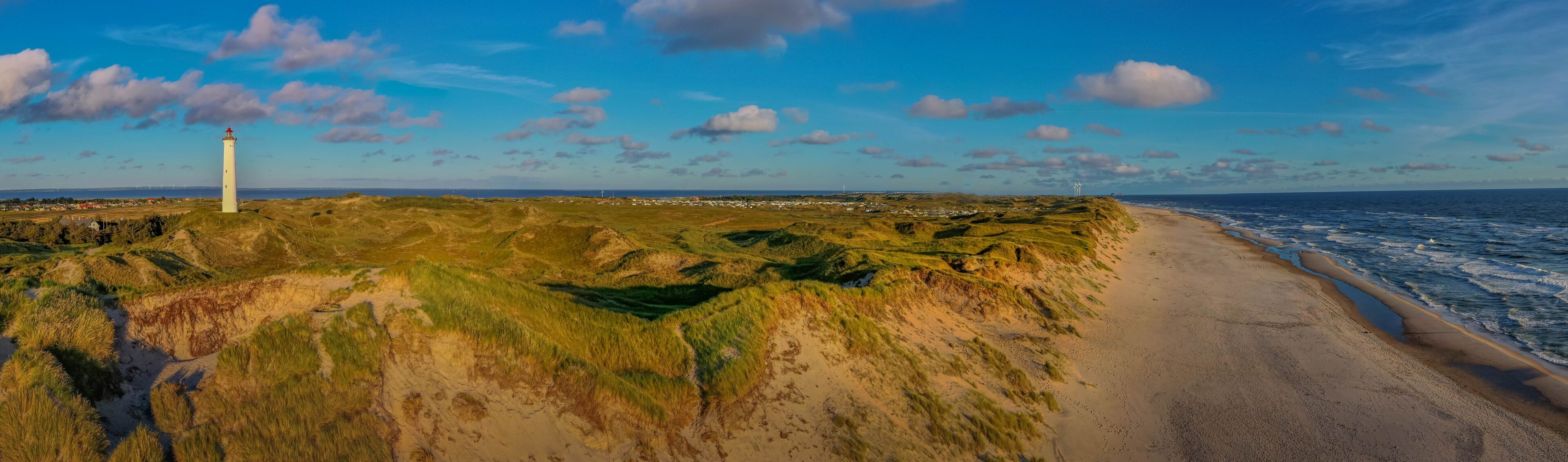 Panoramic aerial view of  Lyngvig lighthouse on wide dune of Holmsland Klit  with beach view on the west coast of Jutland, by Hvide Sande, Denmark