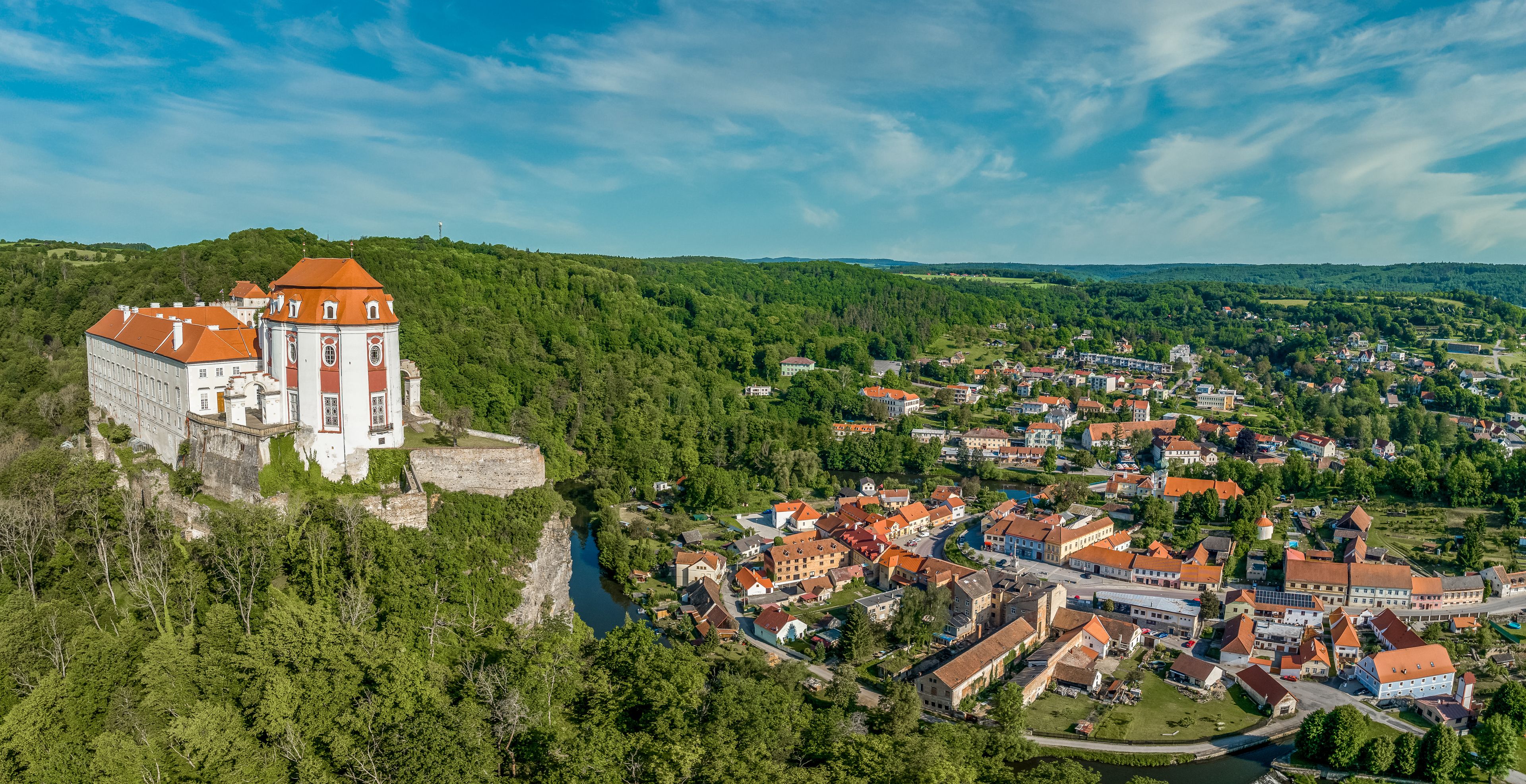 Aerial panorama view of the Thaya river curving at Vranov nad Dyji with old Gothic castle structure turned into a representative Baroque residence with  the extensive landscape park