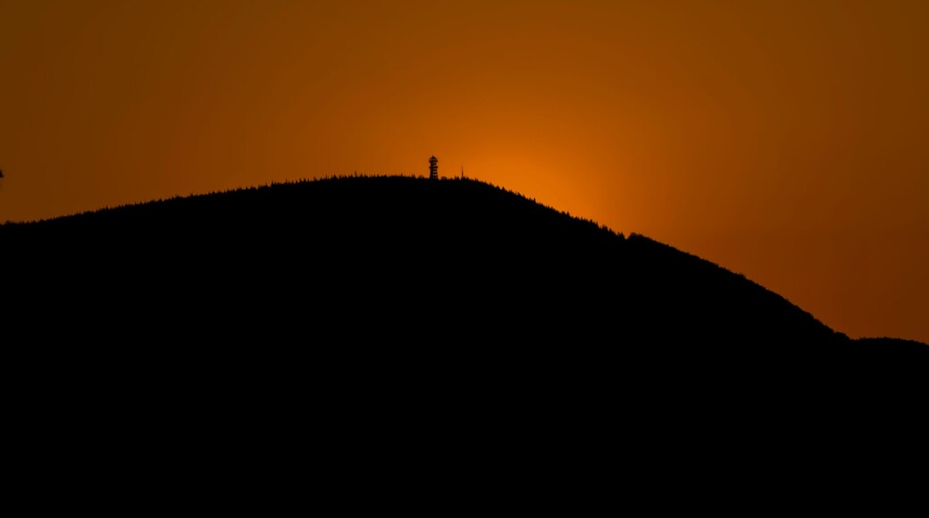 Silhouette of big hill Velky Javornik with observation tower and orange sunset