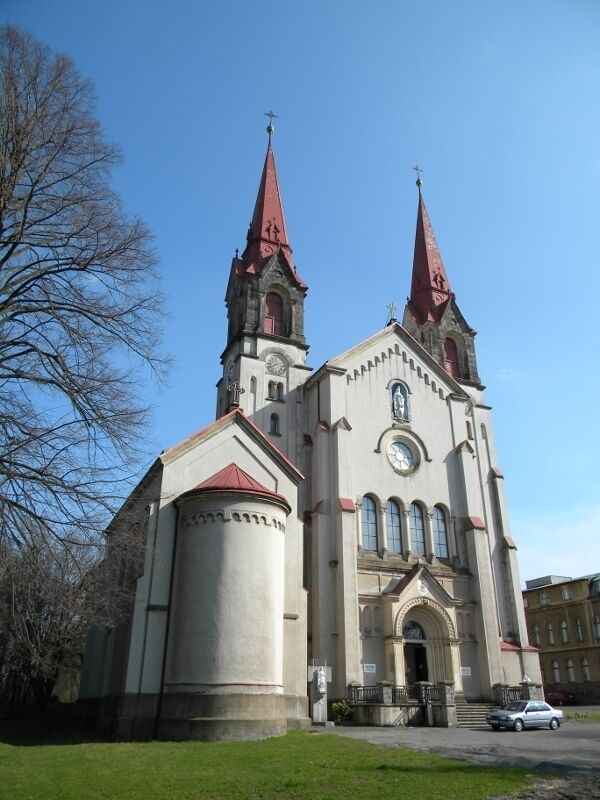 A church with two tall spires and a clock tower.