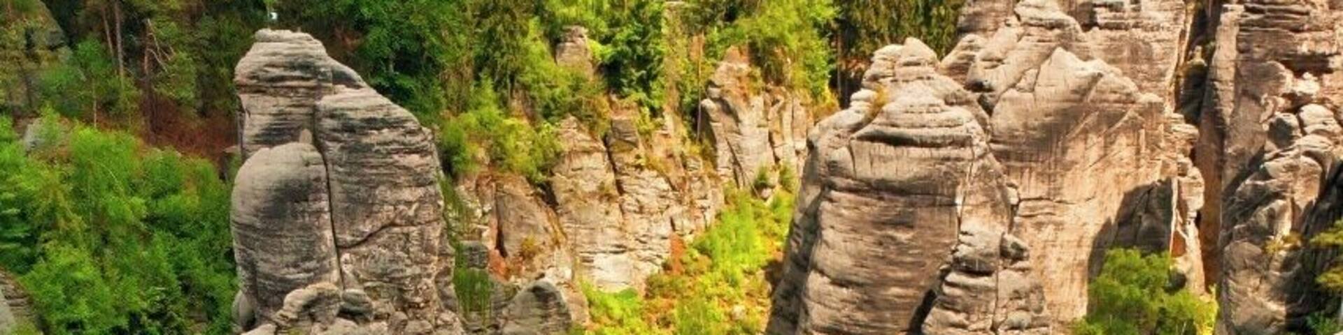 May 2015
Prachovske rocks, Bohemian Paradise, Czech republic
Prachovske skály (=rocks) are the most famous rock town in Czech republic. It was born as a sandstone sediment of a prehistoric ocean some 100 Milion years ago. It was formed by the water, wind, frost, rain and it created numerous rock towers which were in 1933 certified as a nature park reservation. It is situated ca. 100 km northeast from Prague near the town of Jičín.
The view is from the viewpoint Vyhlídka Českého ráje (=Bohemian Paradise) towards the main valley of the area. Each tower has its name, from left Big Kapucin, Monk (the one with a path leading inside of it) and Eagle/Bishop on the right.