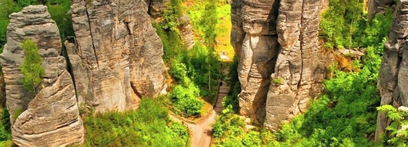 May 2015
Prachovske rocks, Bohemian Paradise, Czech republic
Prachovske skály (=rocks) are the most famous rock town in Czech republic. It was born as a sandstone sediment of a prehistoric ocean some 100 Milion years ago. It was formed by the water, wind, frost, rain and it created numerous rock towers which were in 1933 certified as a nature park reservation. It is situated ca. 100 km northeast from Prague near the town of Jičín.
The view is from the viewpoint Vyhlídka Českého ráje (=Bohemian Paradise) towards the main valley of the area. Each tower has its name, from left Big Kapucin, Monk (the one with a path leading inside of it) and Eagle/Bishop on the right.
