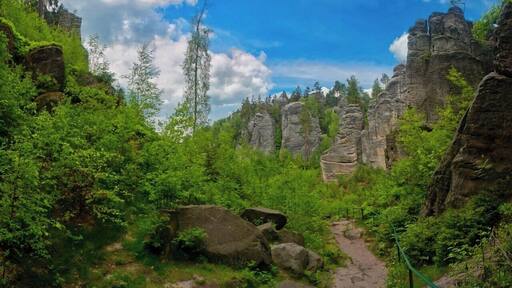 May 2015
Prachovske rocks, Bohemian Paradise, Czech republic
Prachovske skály (=rocks) are the most famous rock town in Czech republic. It was born as a sandstone sediment of a prehistoric ocean some 100 Milion years ago. It was formed by the water, wind, frost, rain and it created numerous rock towers which were in 1933 certified as a nature park reservation. It is situated ca. 100 km northeast from Prague near the town of Jičín.
The view is from the valley bellow the viewpoint Vyhlídka Českého ráje (=Bohemian Paradise). The greyish sandstone rock towers are surrounded by lush green trees and bushes.