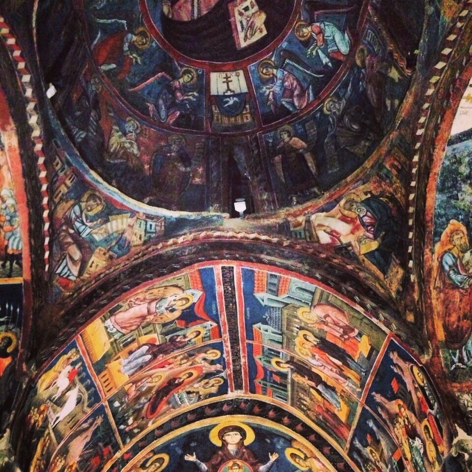 A detailed mosaic ceiling with religious figures and scenes.