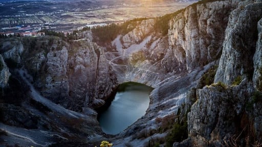 Blue Lake *
(Croatian: Modro jezero or Plavo jezero) is a karst lake located near Imotski in southern Croatia. Like the nearby Red Lake, it lies in a deep sinkhole possibly formed by the collapse of an enormous underground cave. The total depth from the upper rim is around 220 meters, while water depth varies with season. In spring, when the snow from surrounding mountains melts, it can reach 90 m, and in 1914 it reached 114 m, overflowing the southern rim. The lake is a popular destination for hiking and sight-seeing.
Maximum dimensions of the lake are around 800×500 m, but they significantly vary due to big changes in the water level. At the end of the summer the lake may completely disappear.
In 1907 a road was built descending to the lake. In 1942, an earthquake caused a large landfall resulting in reduction of the lake's depth.
#croatia #modrojezero #lake #imotski