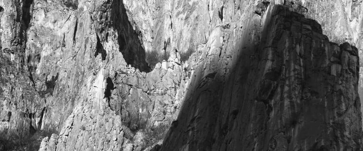 A rugged mountain landscape with sharp peaks and deep valleys.