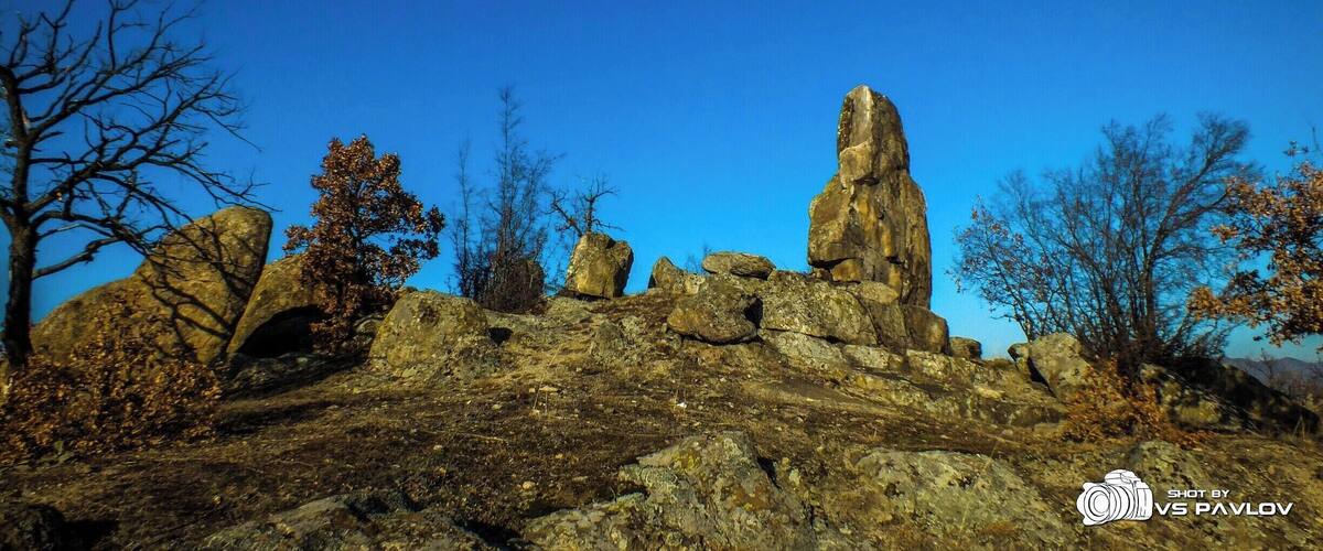 A rocky landscape with prominent rock formations under a clear blue sky.