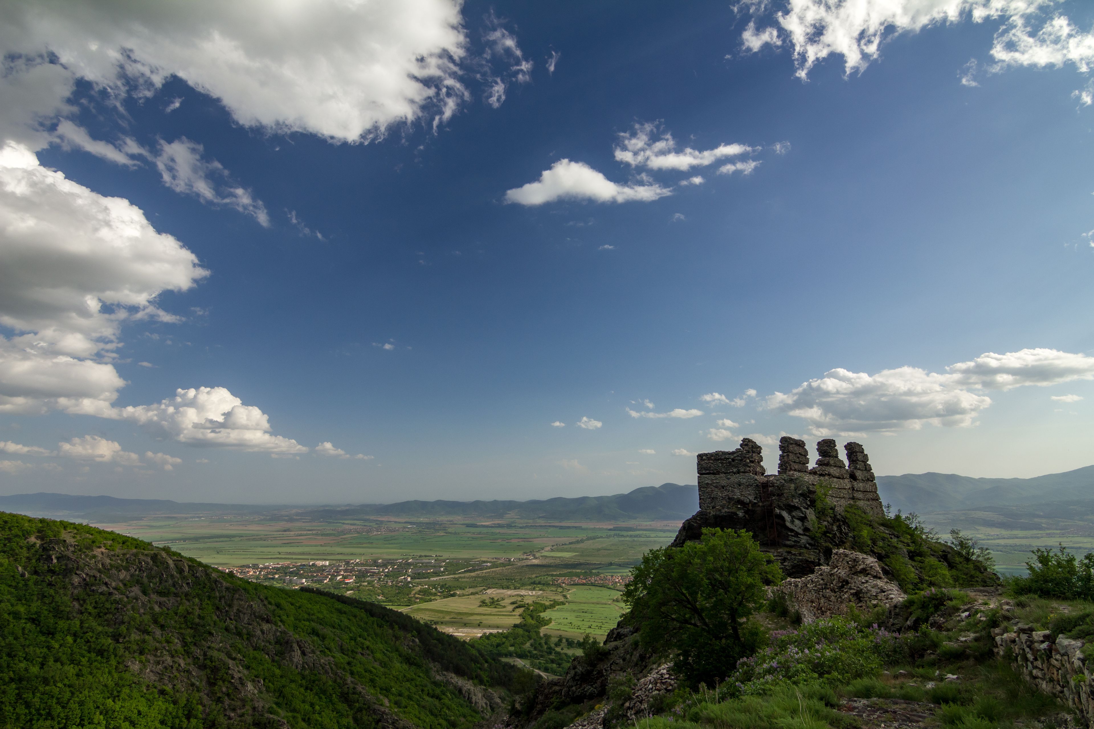 Remains and ruins of medieval fortress called Anevo Kale in Stara Planina mountain near Sopot, Bulgaria, horizontal landscape taken at evening towards the town