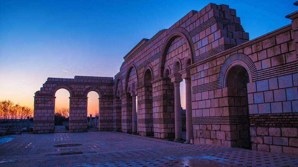 Ancient stone architecture with arches and columns.