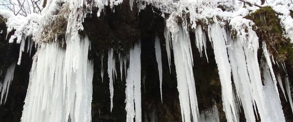 A waterfall with icicles hanging from the top.