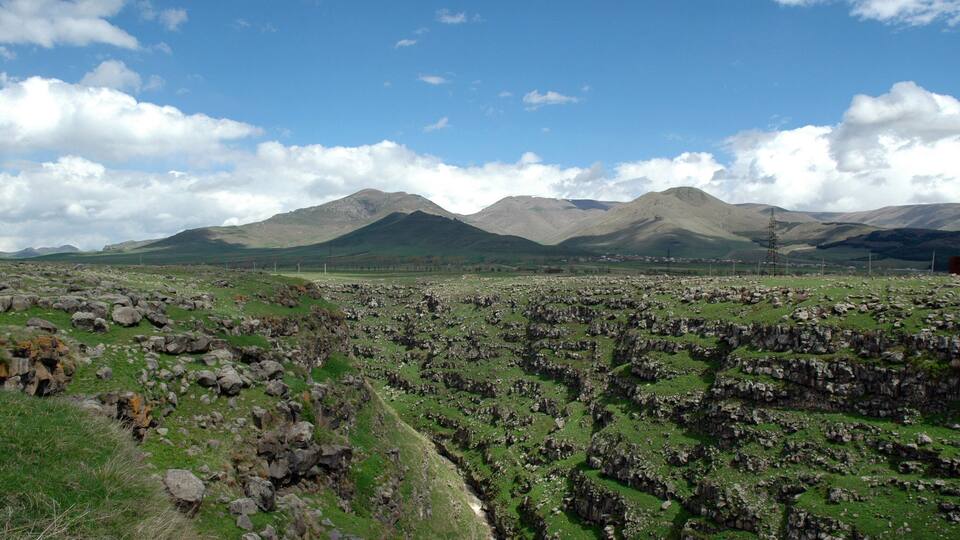A mountainous landscape with rocky terrain and a clear sky.