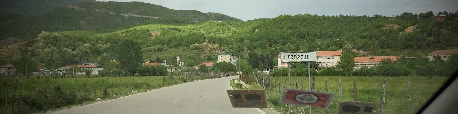 Well, despite being told not to go because a) 'there isn't anything out there' and b) 'you shouldn't trust anyone in the area', I encourage you to head there and sleep there for one night.
Why?
Because of the green hills and red earth that surround this village, vilified in 'Taken' and 'Taken 2', which could serve as an excellent base camp for some hiking, plus the Kosovo border crossing is very close - if you're heading there.
P.S. People are still very friendly, as is the case in the whole of Albania.