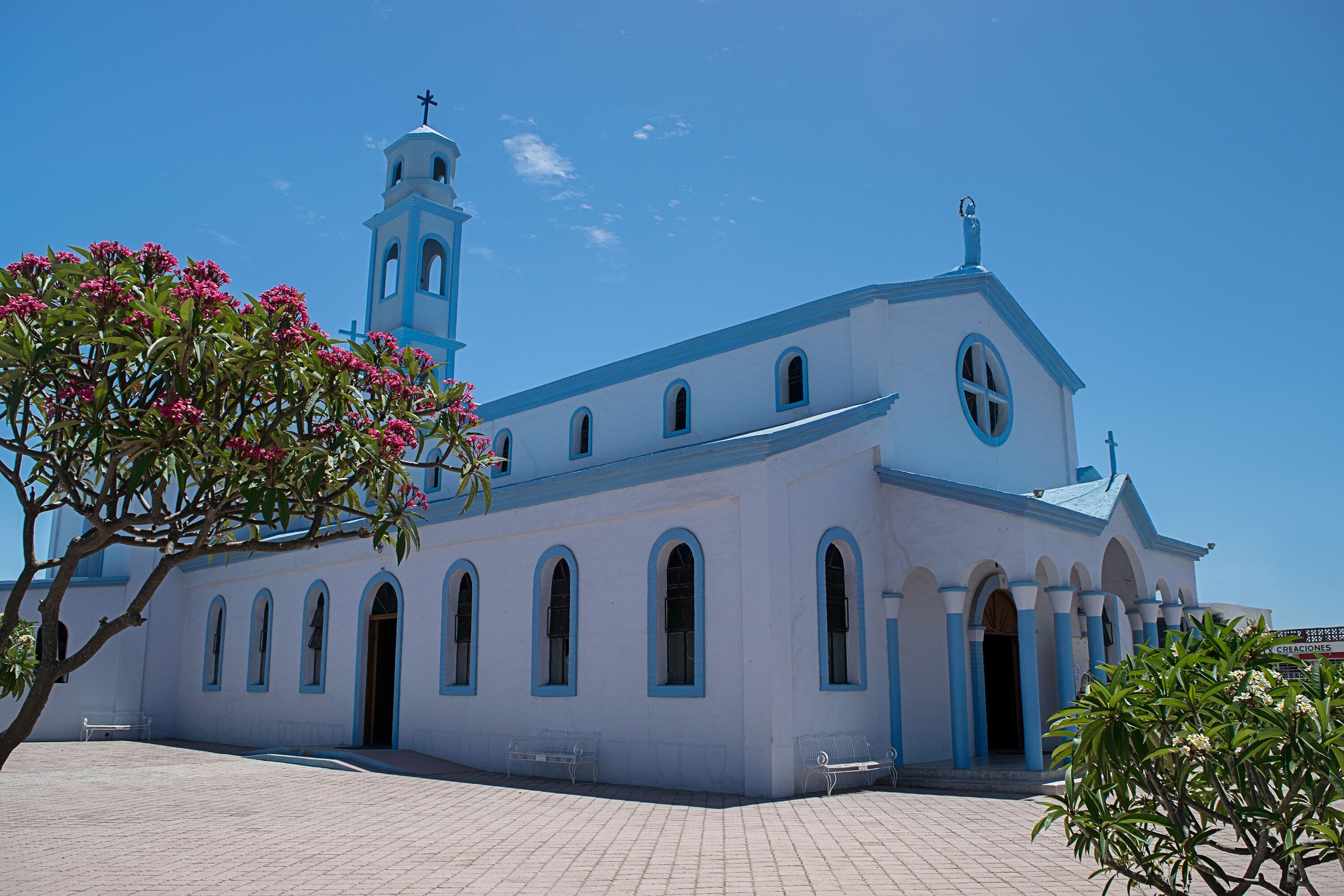 A church with a bell tower and arched windows.