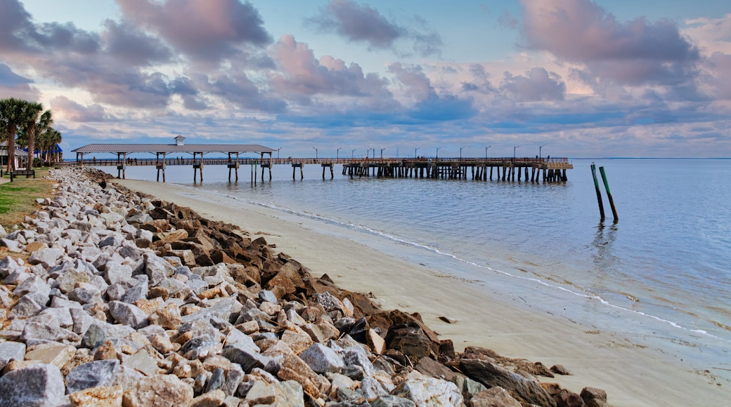 An old fishing pier on St Simons Island beyond rock seawall