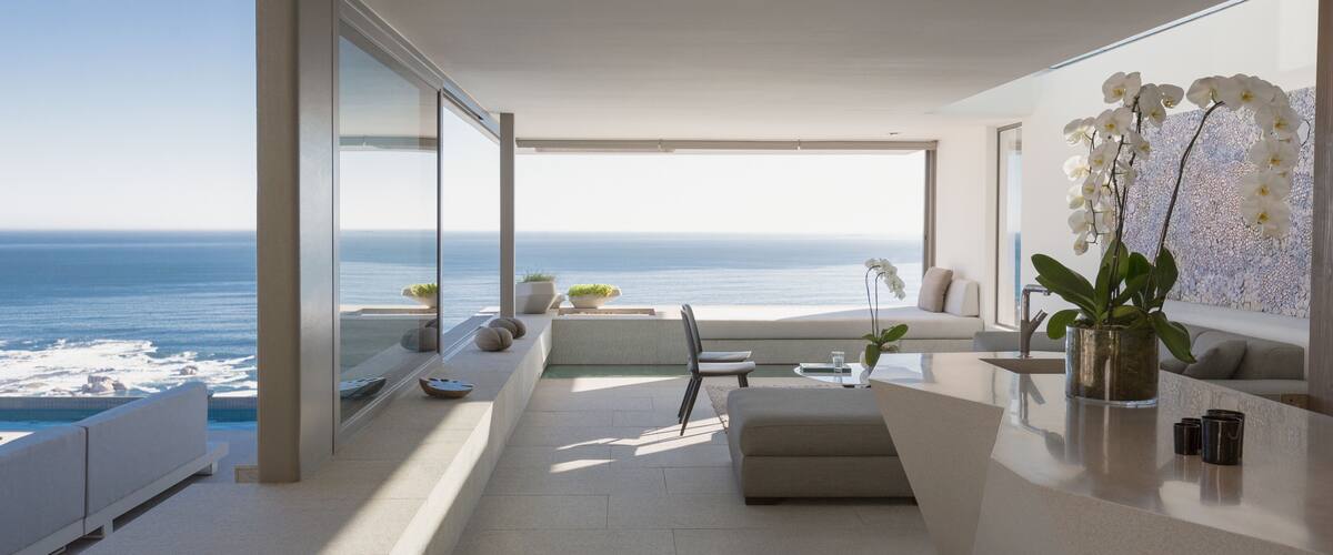 Modern, luxury home showcase interior living room with sunny ocean view