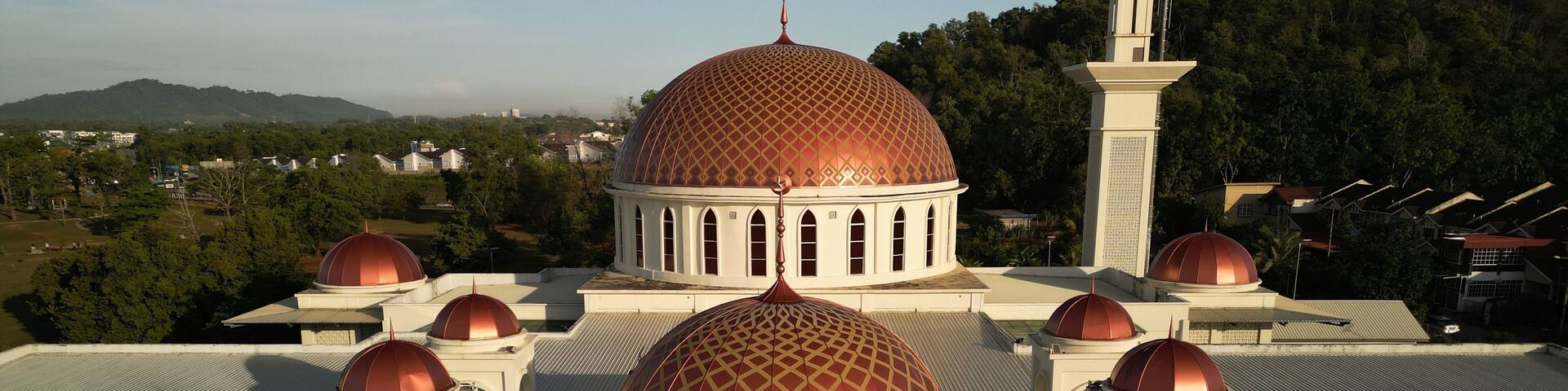 Sungai Petani, Kedah, Malaysia – July 14, 2025 - Aerial morning view of mosque located in Bandar Perdana, surrounded by hills and residential housing area. Editorial use only.