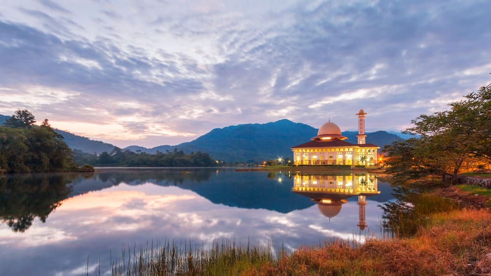 Beautiful view of Darul Quran mosque with reflections during sunset at Kuala Kubu, Selangor, Malaysia.