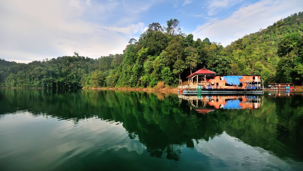 Fishing boat (Houseboat) at tropical rain forest at Kenyir Lake in Terengganu, Malaysia, It is the largest man-made lake in South East Asia.