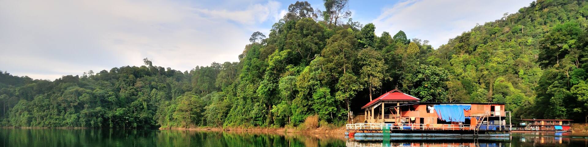 Fishing boat (Houseboat) at tropical rain forest at Kenyir Lake in Terengganu, Malaysia, It is the largest man-made lake in South East Asia.