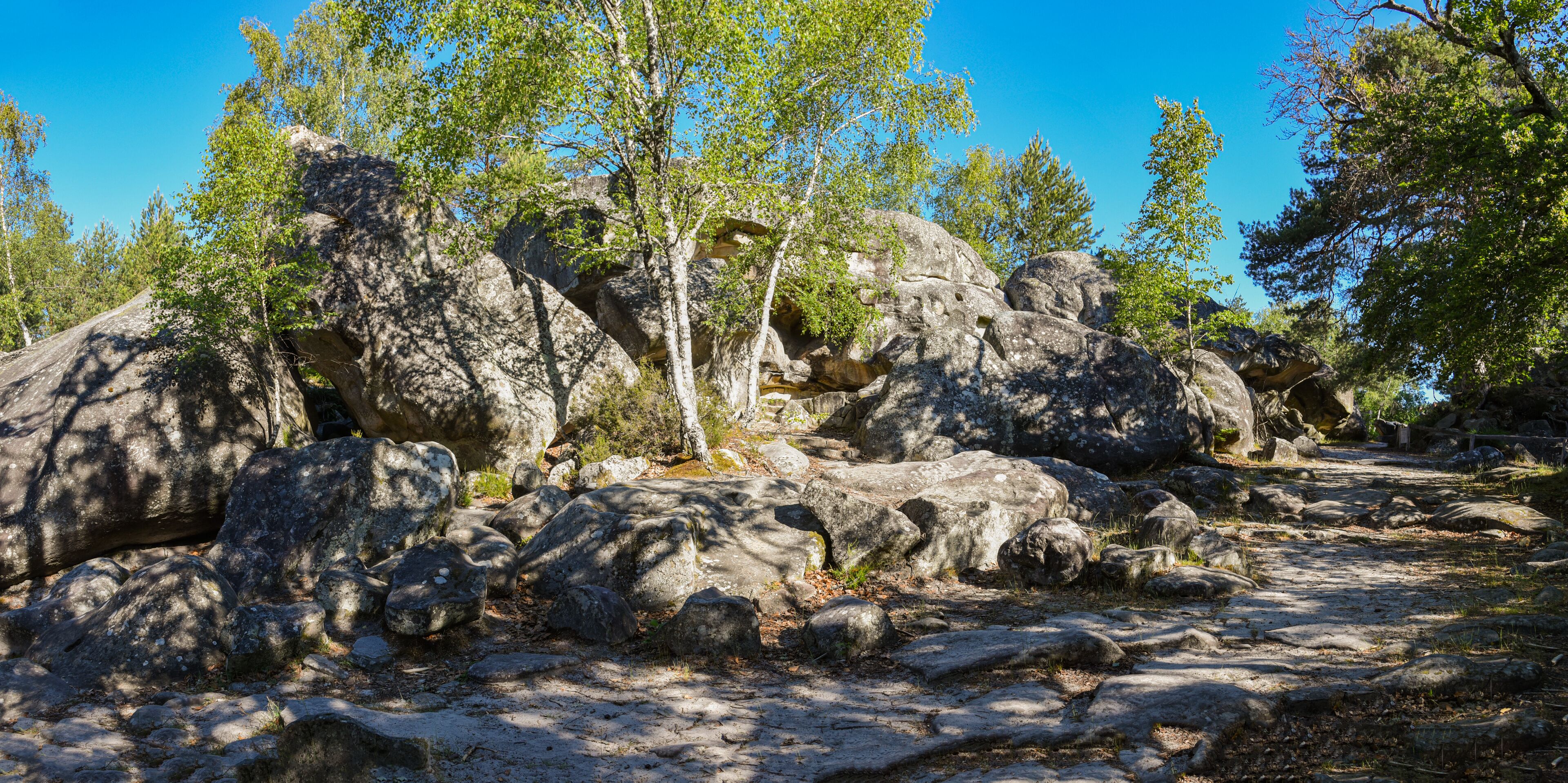 A rocky landscape with large boulders and trees.