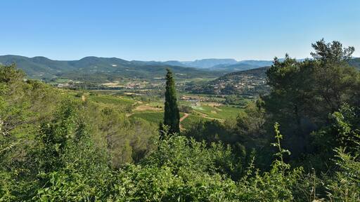 View on the Commune of Pierrerue from the D612 (Departmental Road) and in the background the Massif du Caroux. Cébazan, Hérault, France.