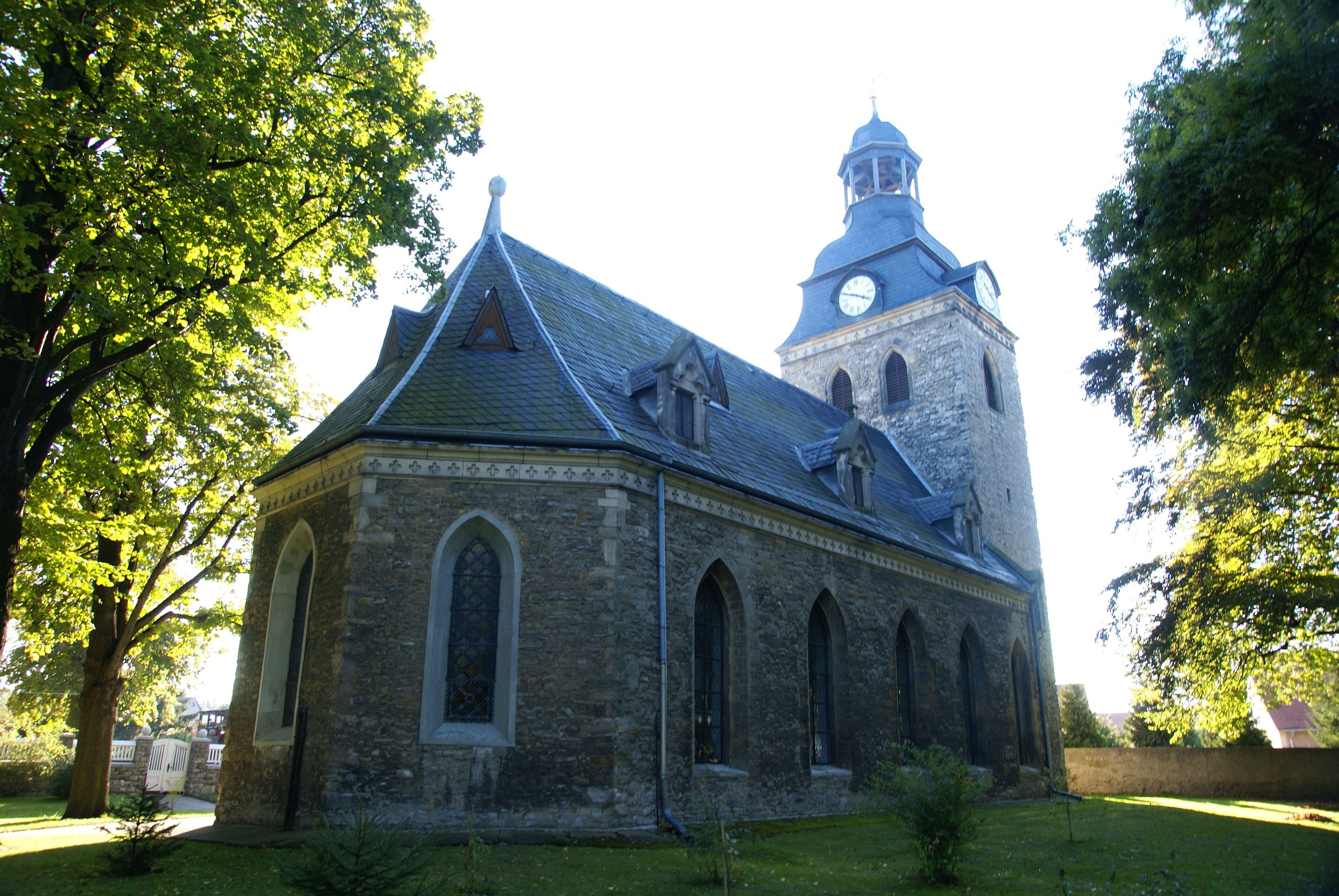 A historic church with a clock tower and arched windows.