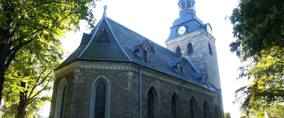 A historic church with a clock tower and arched windows.