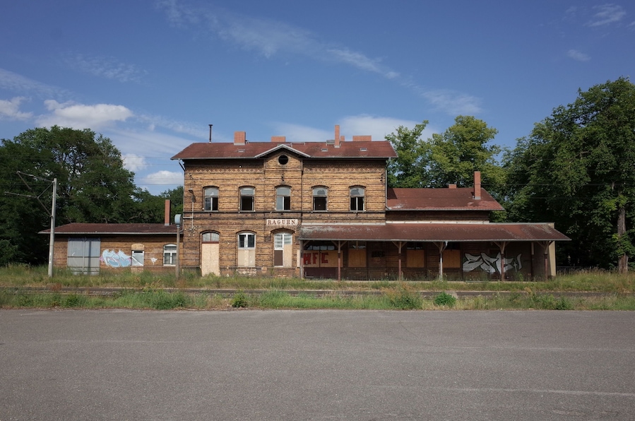 A large, two-story brick building with a sign that reads "RAGHUN" and "HFC" on the front.