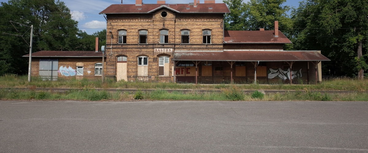 A large, two-story brick building with a sign that reads "RAGHUN" and "HFC" on the front.