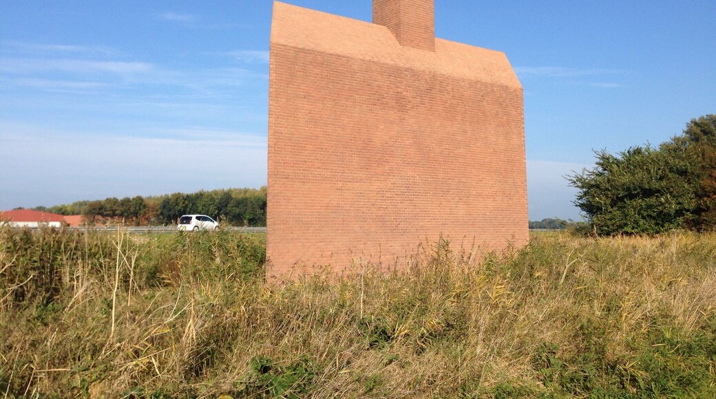 This "Monument Noordoostpolder" is a kind reminder to highway motorists about how much below sea level they are actually -safely- driving. The wave from the chimney also serves as a weather vane. - the ship is going against the currents and the wind.
Making land where the sea once was, is not supposed to be easy. #highway-art
http://www.flevolanderfgoed.nl/home/kunst/noordoostpolder/nagele/monument-noordoostpolder.html