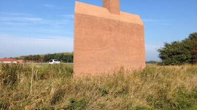 This "Monument Noordoostpolder" is a kind reminder to highway motorists about how much below sea level they are actually -safely- driving. The wave from the chimney also serves as a weather vane. - the ship is going against the currents and the wind.
Making land where the sea once was, is not supposed to be easy. #highway-art
http://www.flevolanderfgoed.nl/home/kunst/noordoostpolder/nagele/monument-noordoostpolder.html