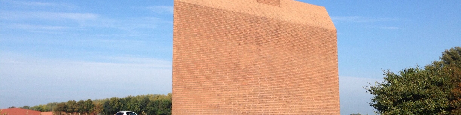 This "Monument Noordoostpolder" is a kind reminder to highway motorists about how much below sea level they are actually -safely- driving. The wave from the chimney also serves as a weather vane. - the ship is going against the currents and the wind.
Making land where the sea once was, is not supposed to be easy. #highway-art
http://www.flevolanderfgoed.nl/home/kunst/noordoostpolder/nagele/monument-noordoostpolder.html