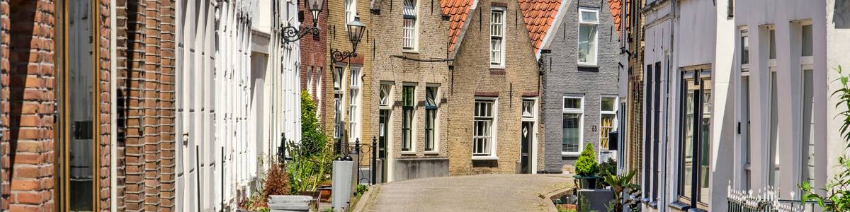 Zwartewaal, The Netherlands, June 12, 2021: traditional houses with brick and plaster facades in the village's main street on a sunny day