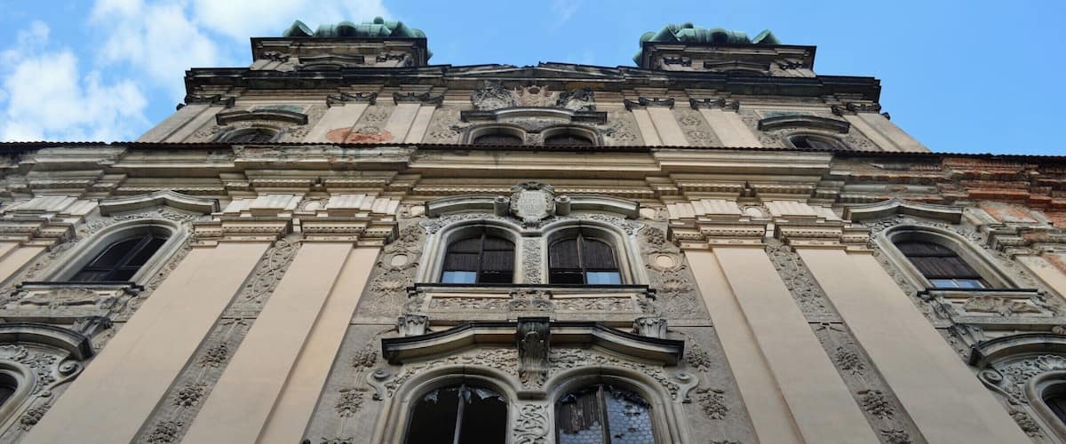 A historic building with ornate architectural details, including statues and decorative moldings.