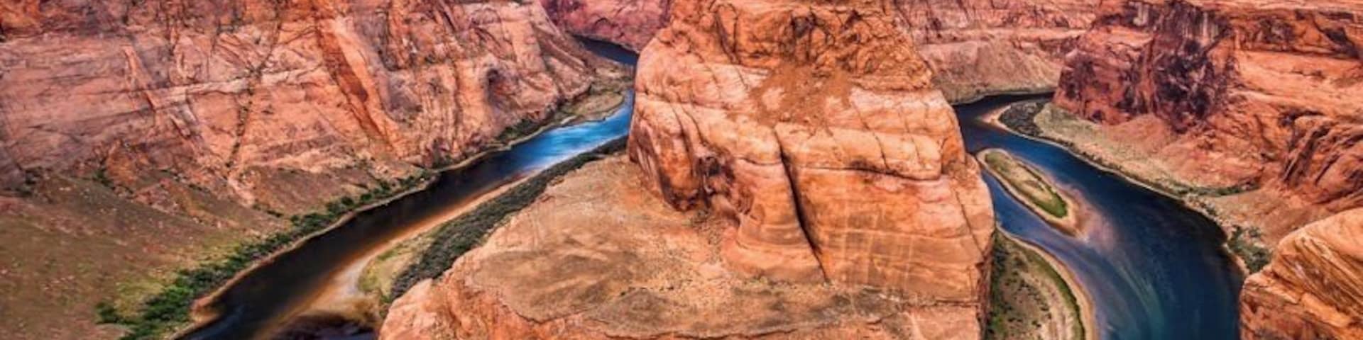 Located within a few hours drive from Las Vegas is this horseshoe shaped meander of the Colorado River. After a bit of a hike, we got to see the horseshoe bend. What an astounding beauty it was!
Also extremely nerve-wracking because it is a merciless 1000 feet drop from the canyon cliffs, and there are no rails at the edge of the cliffs. Being acrophobic made it worse! But it is an experience of a lifetime and I’m glad I mustered all of my courage (I have very little of it), prayed all the Gods in the world (although I believe there is only God) and peeked at the formation of the horseshoe bend among the deep gorges.
To get an elaborate view of the horseshoe bend, I lay down on my stomach and literally crawled on the canyon to reach the edges. The only thing I hoped is, the cliffs were strong enough to hold my weight. And here I was, literally at the edge of a 1000 feet high cliff with my palms sweating (literally!).