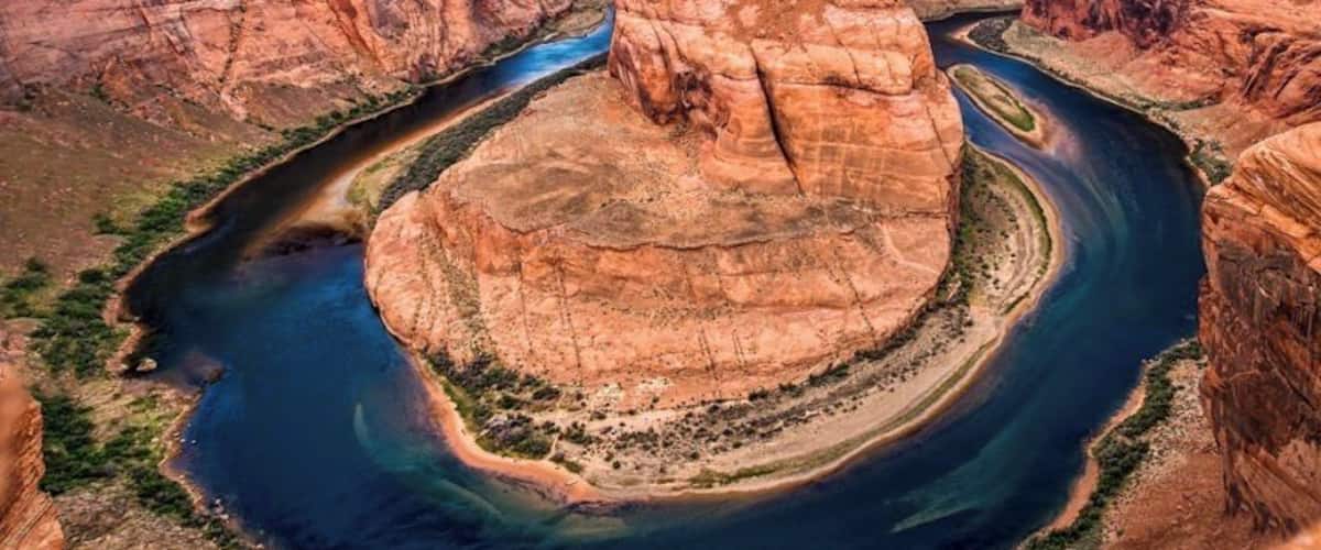 A canyon with a river winding through it.
