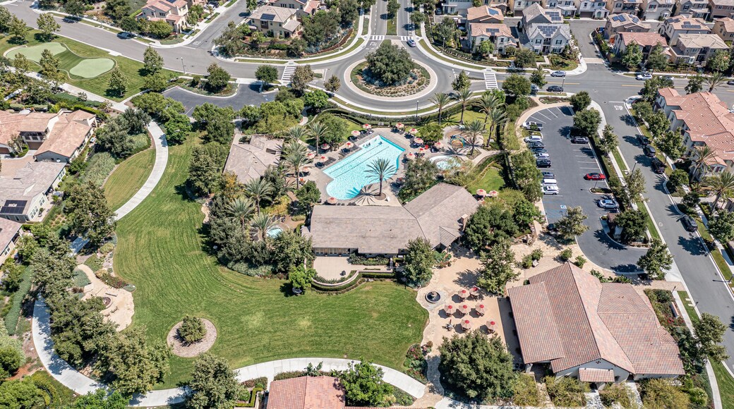Aerial view of roundabout, pool, park, and clubhouse for a master planned community in Southern California.