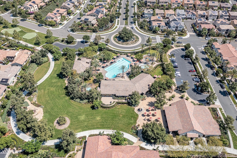 Aerial view of roundabout, pool, park, and clubhouse for a master planned community in Southern California.