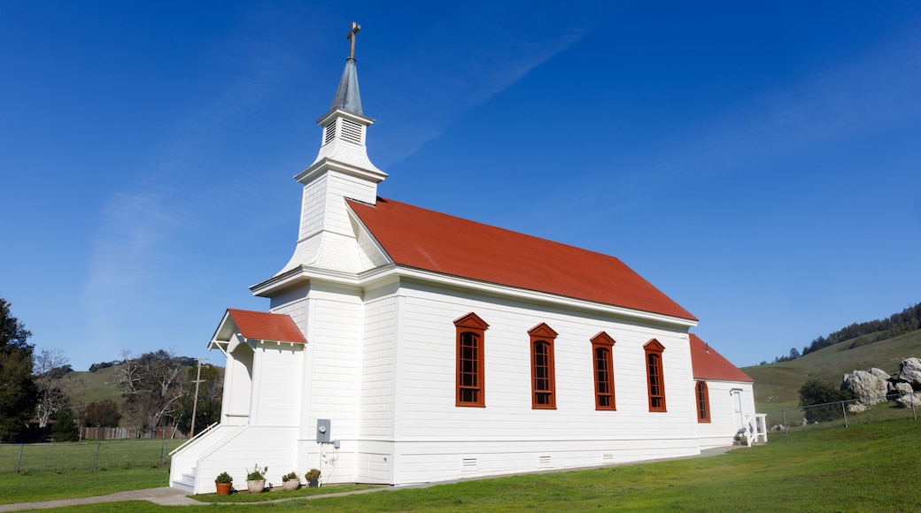 A white church with a red roof and a steeple.