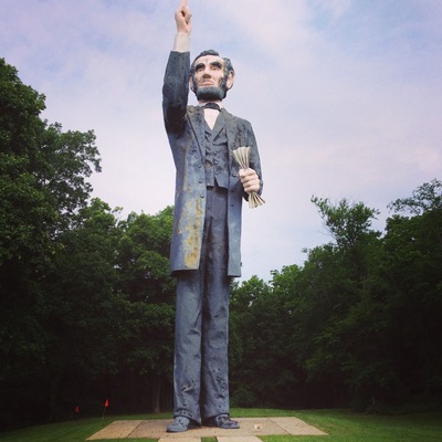 There's a small break in the chain link fence all the way to the left- near the highway. This place is closed, but this is the worlds Tallest Abraham Lincoln. That's my dog near his foot.
