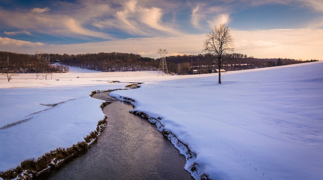 Stream through a snow covered farm field in rural Carroll County