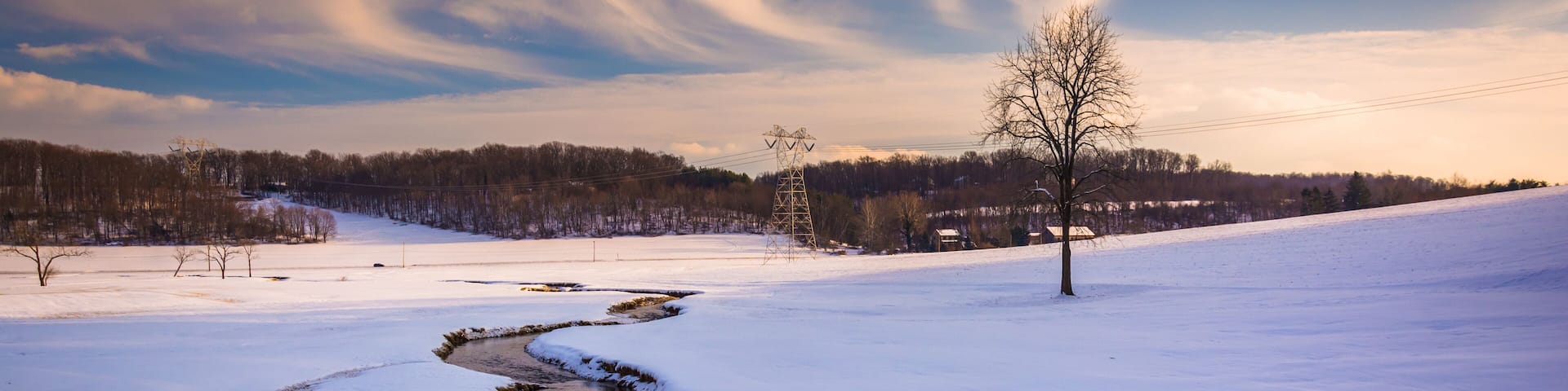Stream through a snow covered farm field in rural Carroll County