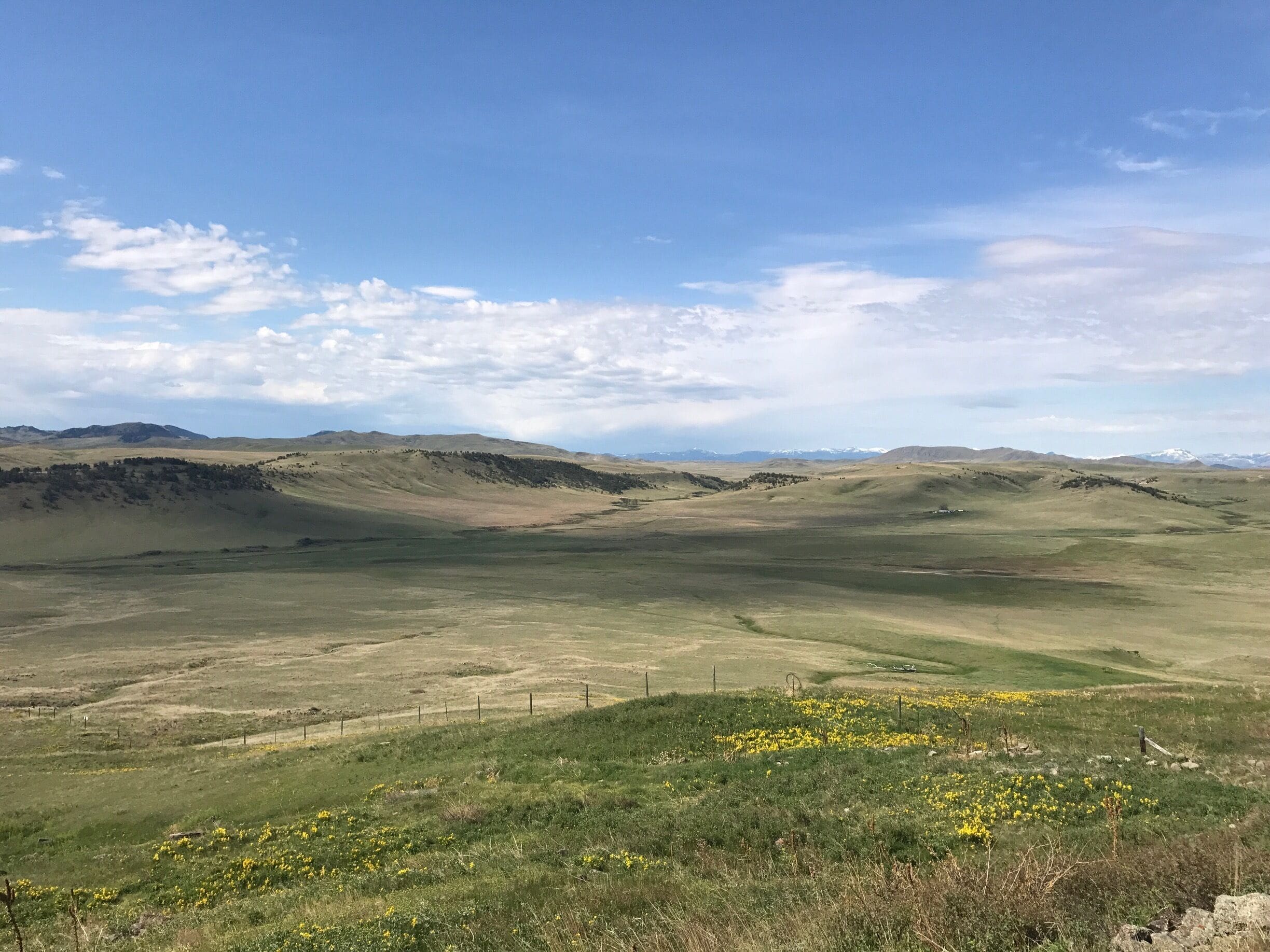 A vast open landscape with rolling hills and a clear sky.