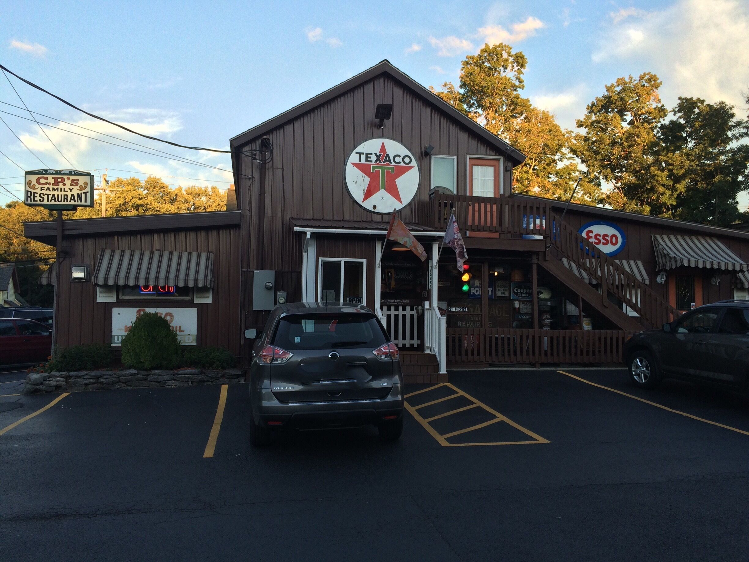 A Texaco gas station with a family restaurant, a Phillips St. repair shop, and a sign for Esso.