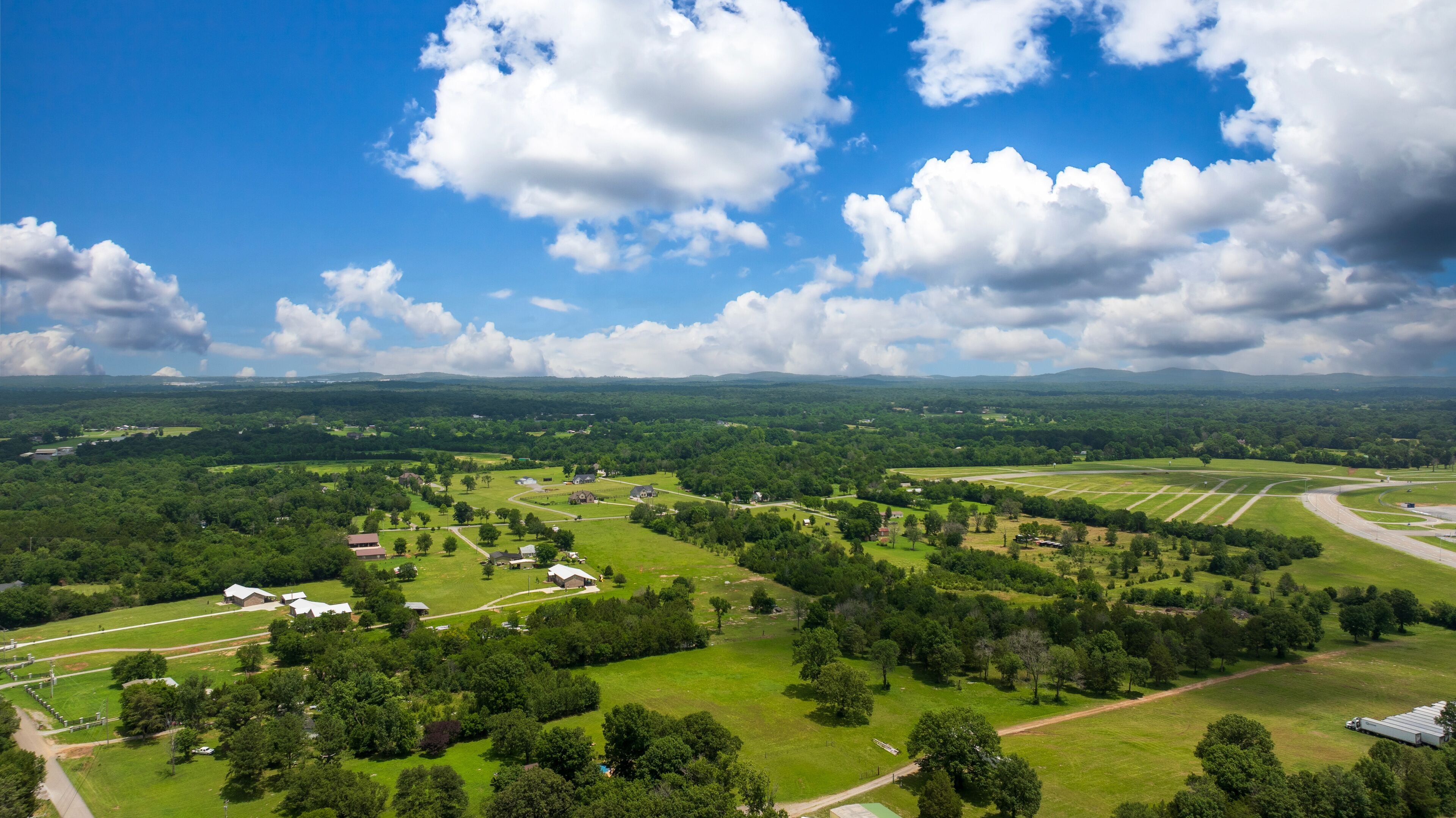 aerial shot of vast miles of lush green trees and homes at the Nashville Superspeedway in Lebanon Tennessee USA